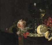 A 'Roemer' with white wine, a partially peeled lemon, cherries and other fruit on a silver plate with a rose and grapes on a stone ledge